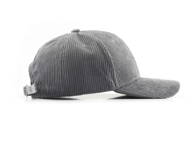 Side view of a gray ribbed corduroy boyfriend baseball cap with a curved brim and adjustable back strap on a white background.