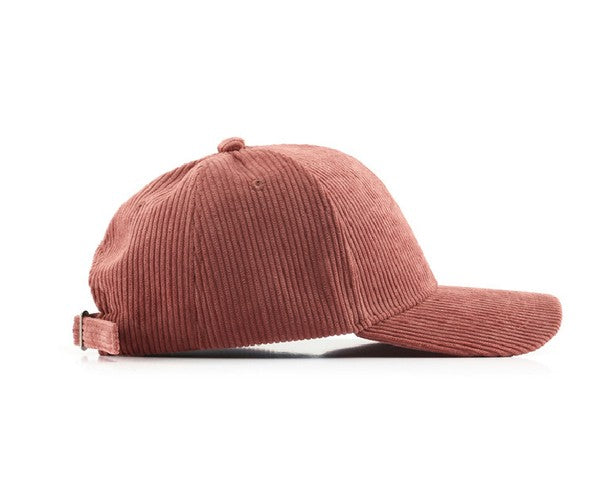 Side view of a mauve corduroy boyfriend baseball cap with a curved brim, adjustable back strap, and relaxed fit on a white background.
