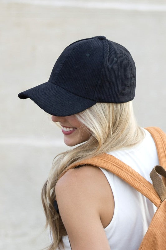 Front view of a black corduroy boyfriend baseball cap with a classic six-panel design and curved visor.