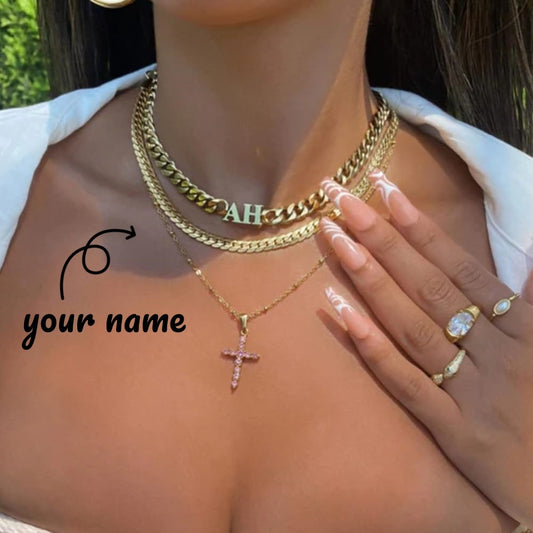 Person wearing gold necklaces and rings with 'your name' text. Customize cuban chain necklace with your name on it. Have a chain made with your name on it. 