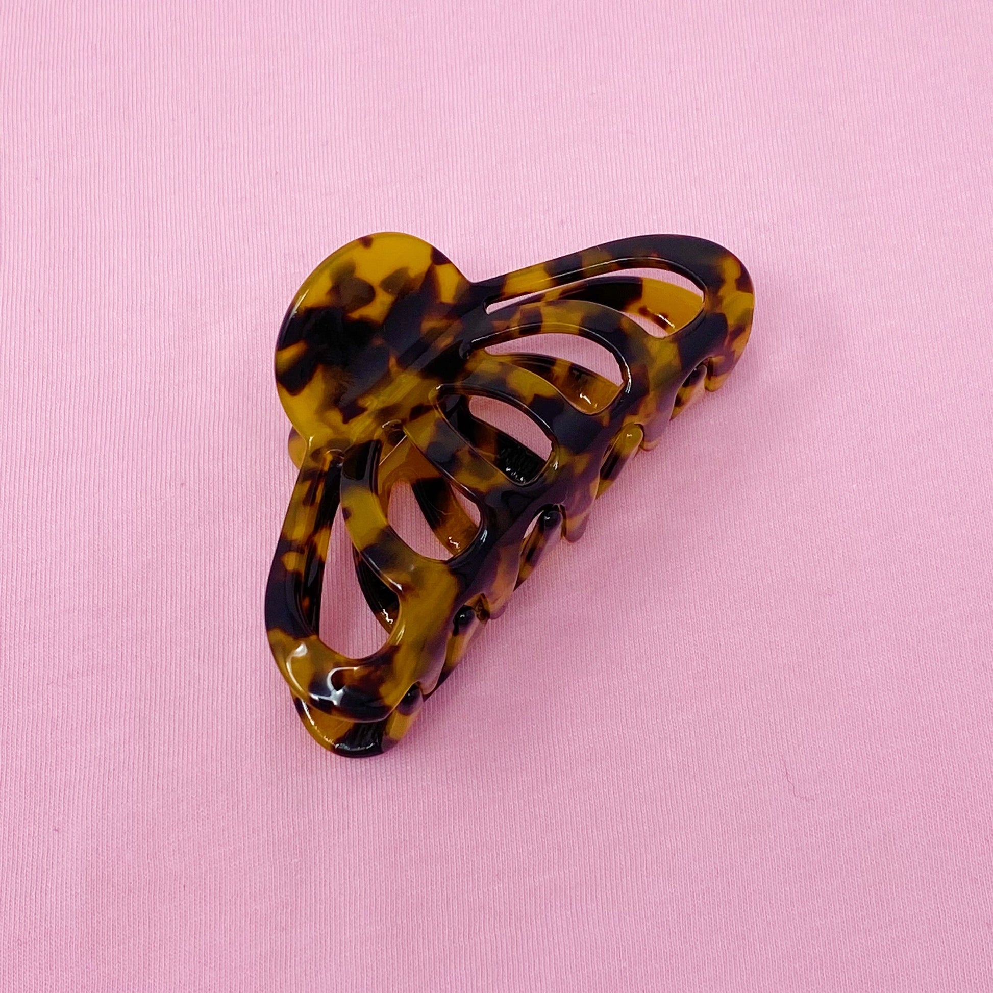 Tortoiseshell hair clip on a pink background
