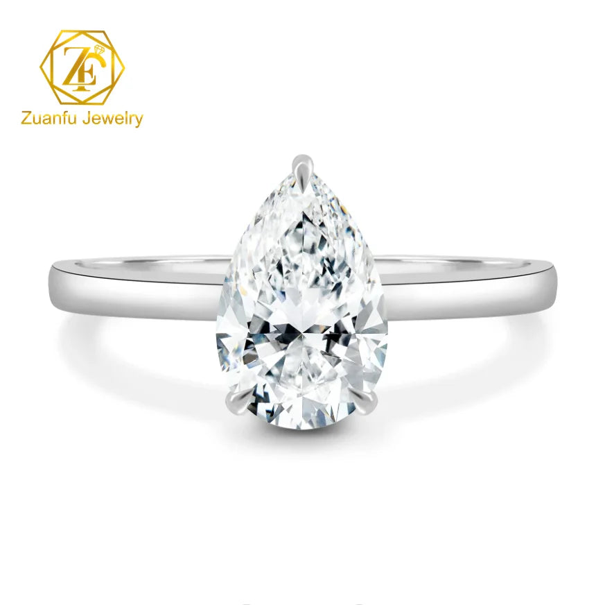 Silver ring with a pear-shaped diamond on a white background, featuring Zuanfu Jewelry logo.