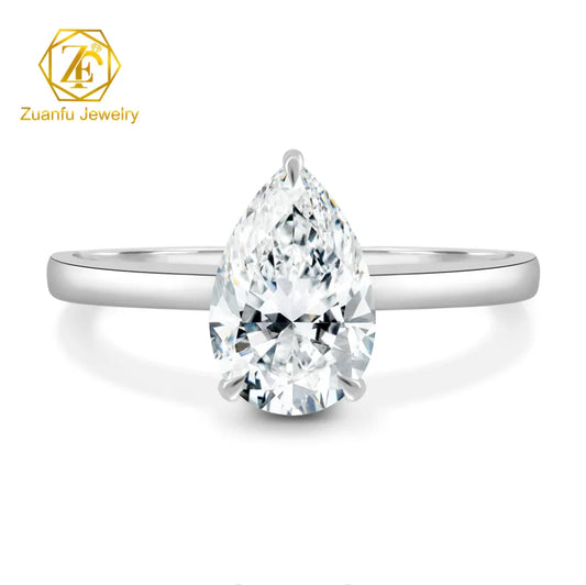 Silver ring with a pear-shaped diamond on a white background, featuring Zuanfu Jewelry logo.