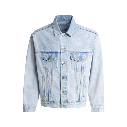 Light blue stonewashed denim trucker jacket with long sleeves, button-front closure, flap chest pockets, and loose fit on a white background.