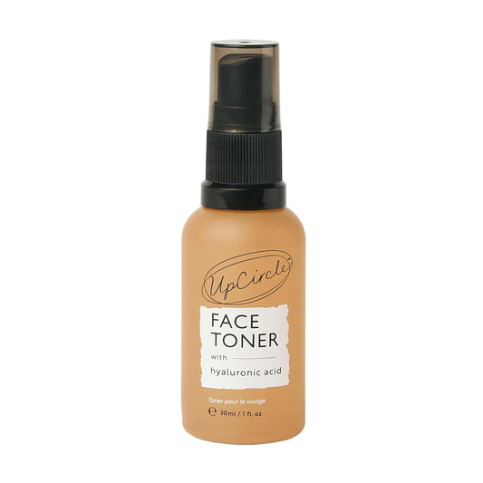 UpCircle Face Toner bottle with a white label on a light beige background. Face Toner with Hyaluronic Acid - Travel Size
