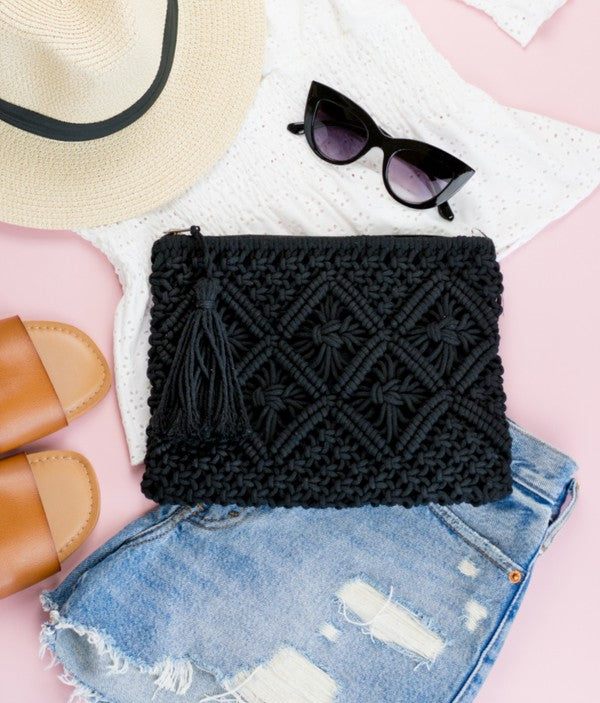 This charming macramé clutch features intricate woven detailing, a lined interior that protects your items, and a hidden open pocket Carry your essentials in soft boho-chic style. This charming macramé clutch features intricate woven detailing, a lined interior that protects your items, and a hidden open pocket for the little things. Finished with a zip closure and a playful tassel accent—perfect for nights out or travel days.

Black colored Macrame Tassel Clutch Woven macramé clutch purse