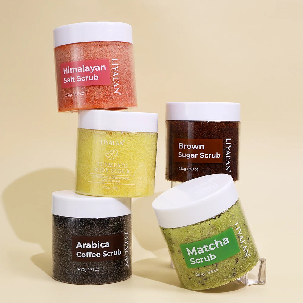 Five jars of Lyman's body scrubs in different flavors on a beige background
