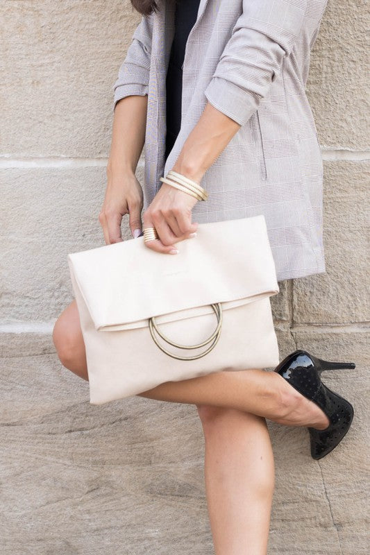Women's bone beige fold-over clutch purse with antique bronze O-ring handle, envelope silhouette, and soft faux leather construction. Elegant neutral handbag featuring a fold-over flap closure and roomy interior, ideal for weddings, evening events, cocktail parties, date nights, business casual outfits, vacations, and everyday wear. Designer-inspired beige clutch bag combining timeless sophistication, versatility, and modern fashion.