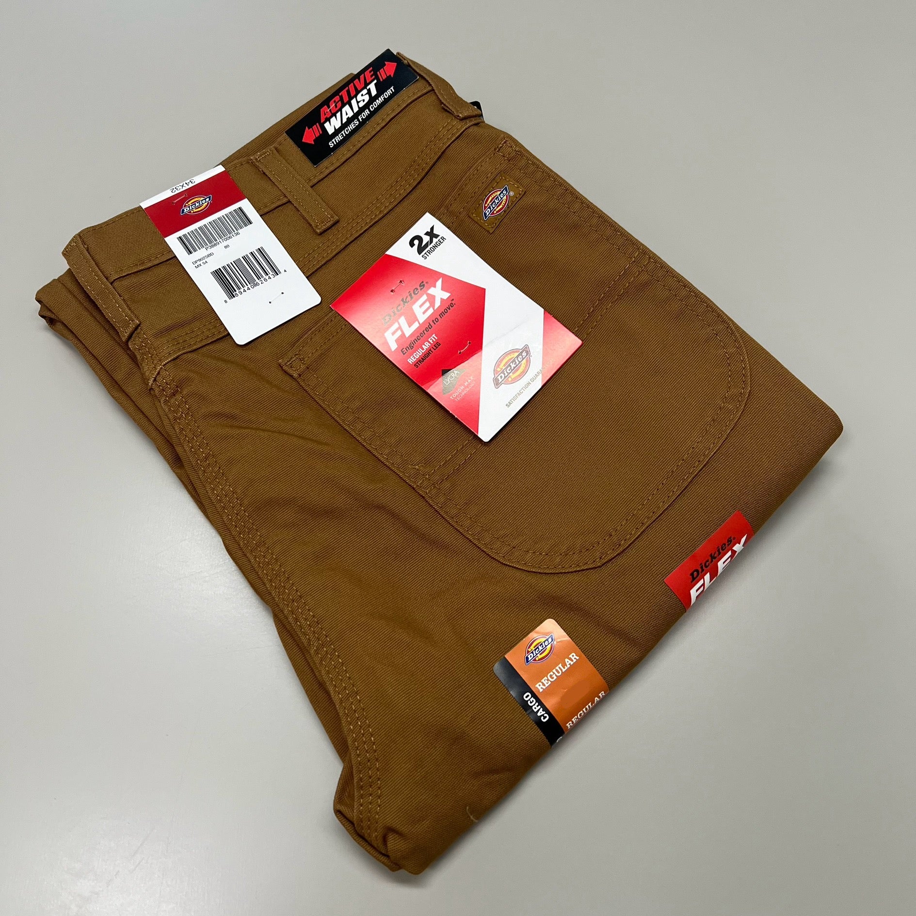 Folded brown pants with Dickies branding on a gray background. Brown pants with Flex and Dickies branding on a beige background DICKIES PANTS WITH POCKETS