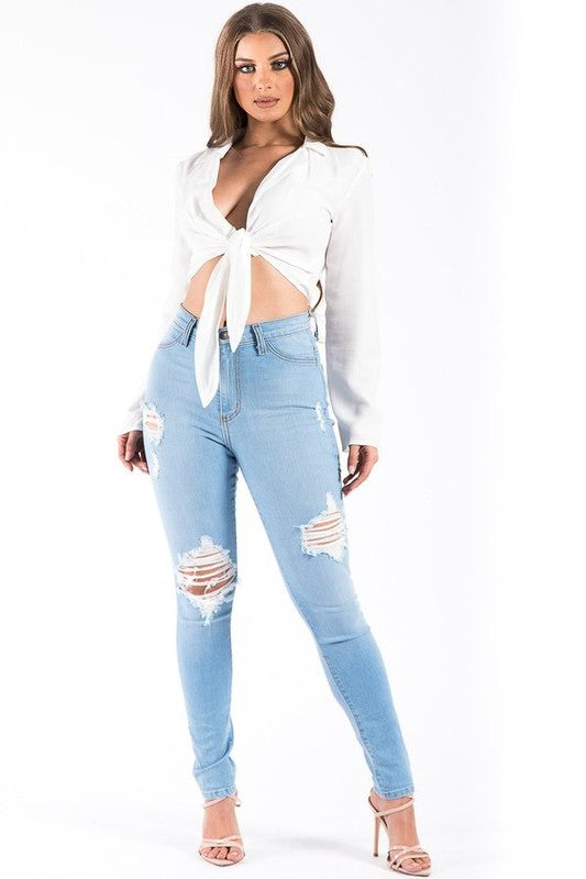 Full Length High Rise Skinny Jean features ripped detail, front button and zipper closure