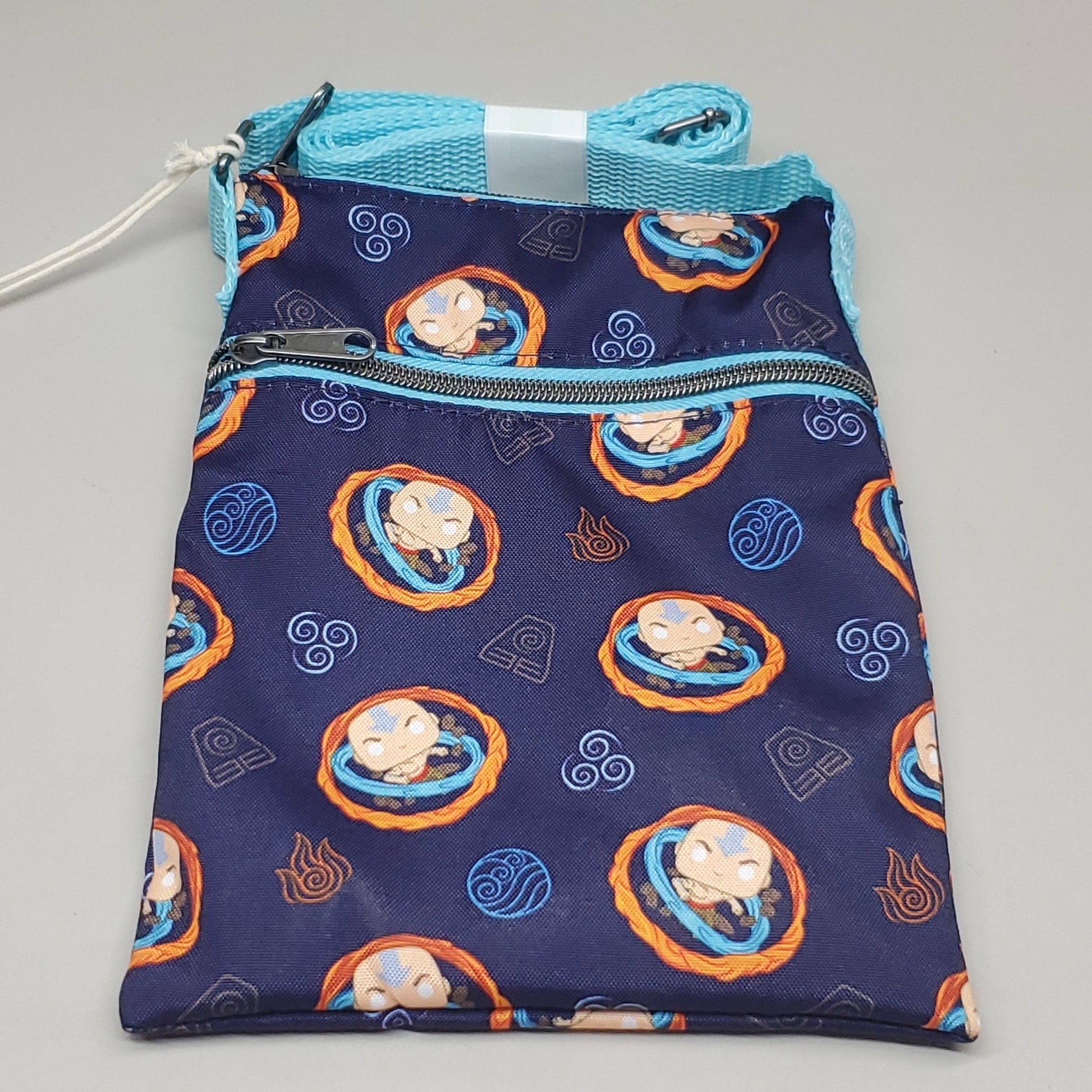 Navy blue pouch with cartoon character pattern on a gray background