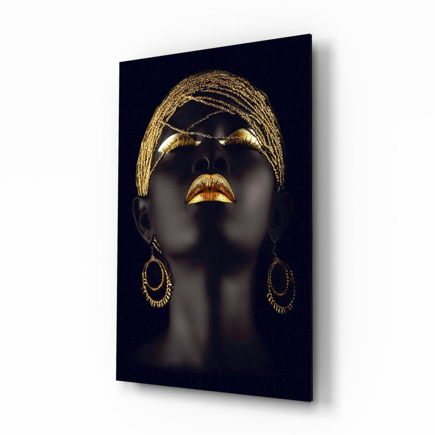 Mannequin head with gold headscarf, lipstick, and earrings on a black background. Gold Beaded Headdress Woman Glass Wall Art