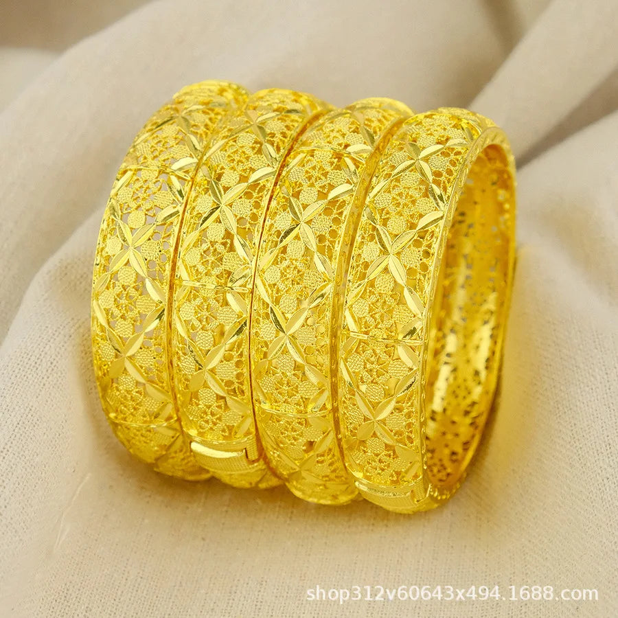 Gold bracelet with intricate design on a beige fabric background