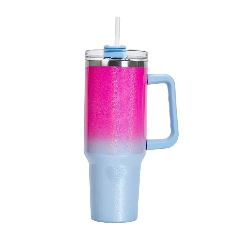 Gradient pink to blue tumbler with handle and straw on a white background