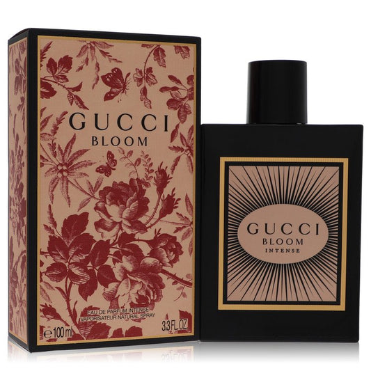 Gucci Bloom Intense perfume shown with its black and beige floral box and the black rectangular bottle with a black cap on a white background. Gucci Bloom Intense by Gucci Eau De Parfum Spray 3.3 oz for Women