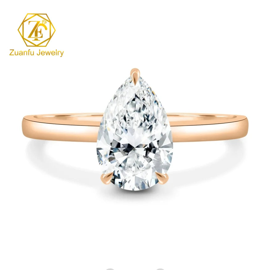 Rose gold ring with a large teardrop-shaped diamond on a white background, featuring the Zuanfu Jewelry logo.