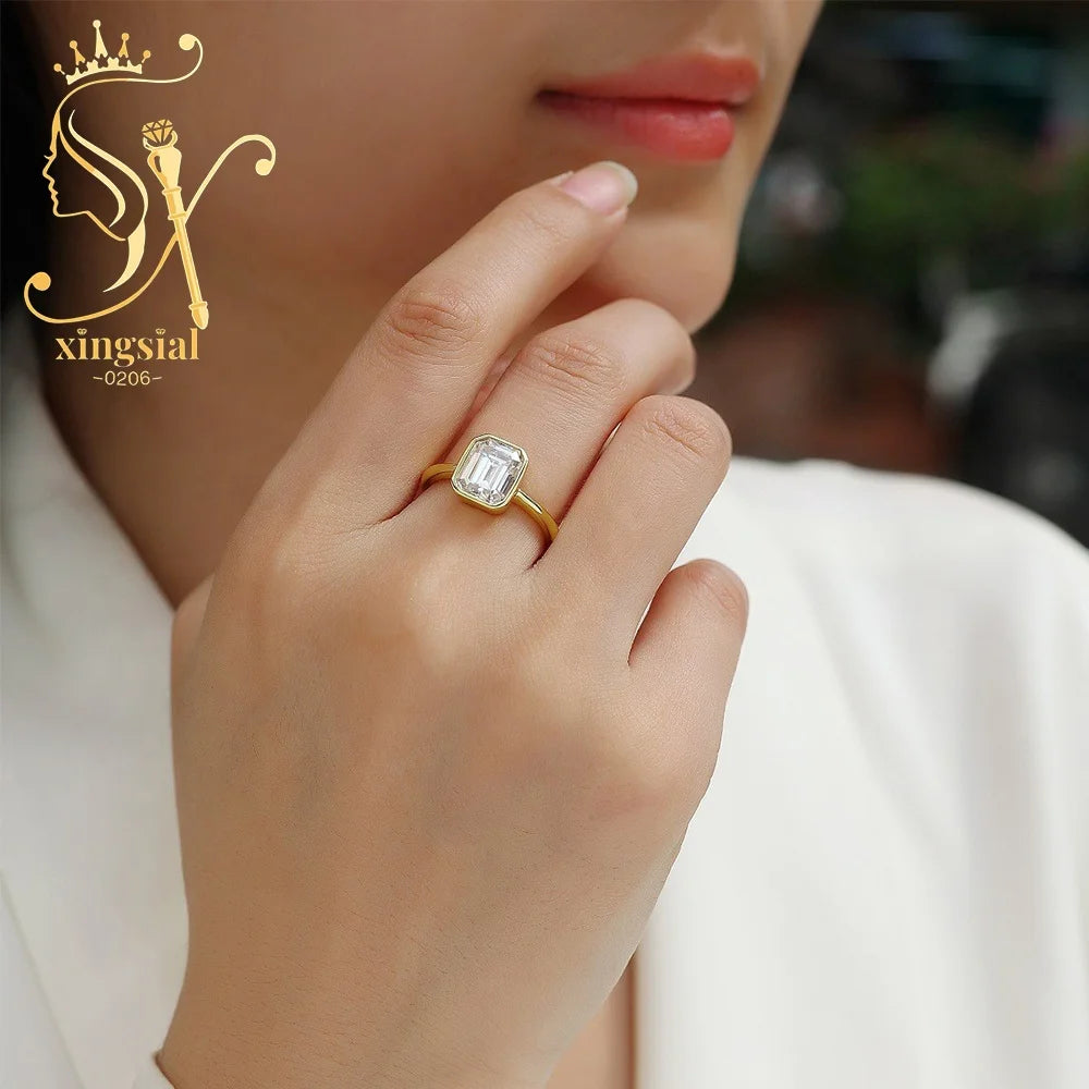 Gold ring with a diamond on a hand, featuring the Xingsial brand logo.