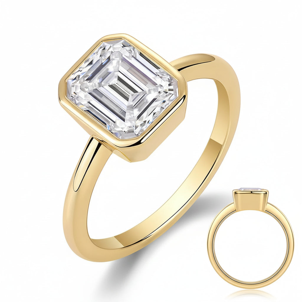 Gold ring with emerald-cut diamond on a white background, featuring the brand 'xingsial'.