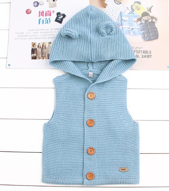 Light blue knitted vest with buttons on a white background