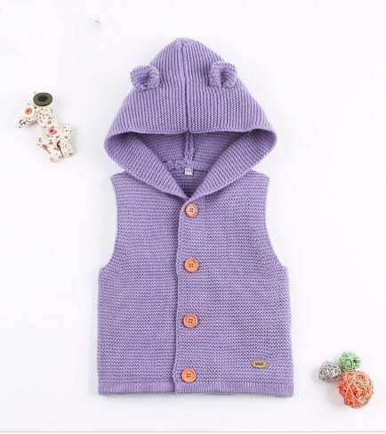 Purple knitted baby vest with buttons on a white background