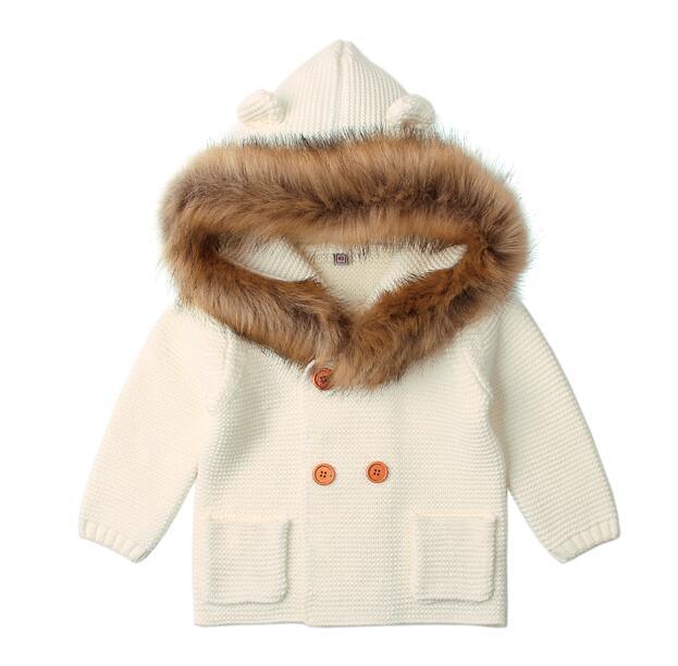 Children's cream-colored coat with fur hood on a white background