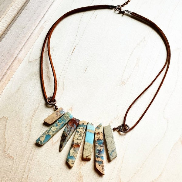 Dive into effortless elegance with this handcrafted Aqua Terra necklace, where genuine stones meet supple leather in perfect harmony. The adjustable design stretches from 18" to 24"—just pull the cords to find your sweet spot. Layer it with your favorites or let it shine solo as a stunning statement piece. Since each one is lovingly made by hand, yours is truly one-of-a-kind. Nature's artistry, personalized just for you.