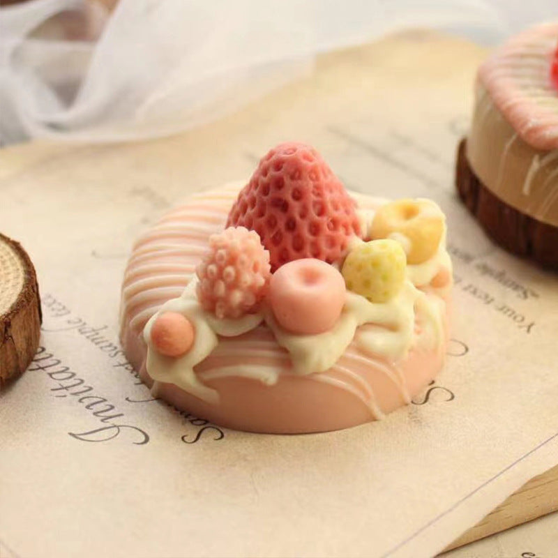 Decorative soap with fruit toppings on a textured surface