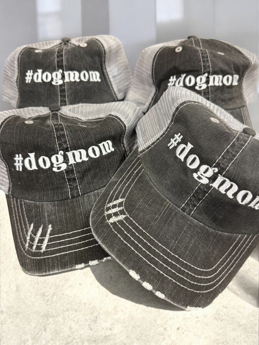 Four black and gray distressed hats with '#dogmom' text on a light background. Hashtag dogmom Embroidered Trucker Hat