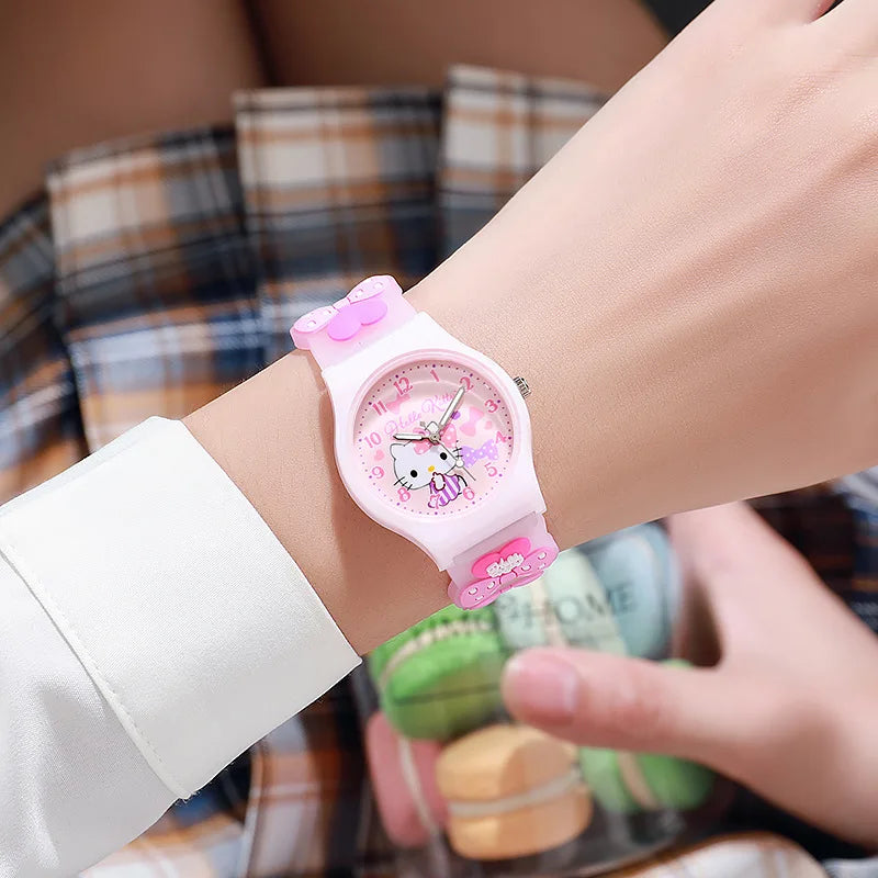 Pink cartoon-themed watch on a wrist with a blurred background