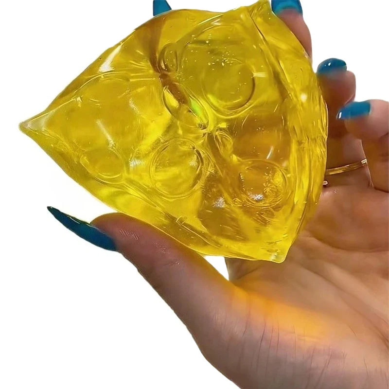 Hand holding a yellow honey cheese squishy toy made of soft transparent mochi gel, featuring realistic cheese-hole details, sensory stress relief fidget toy on a white background.