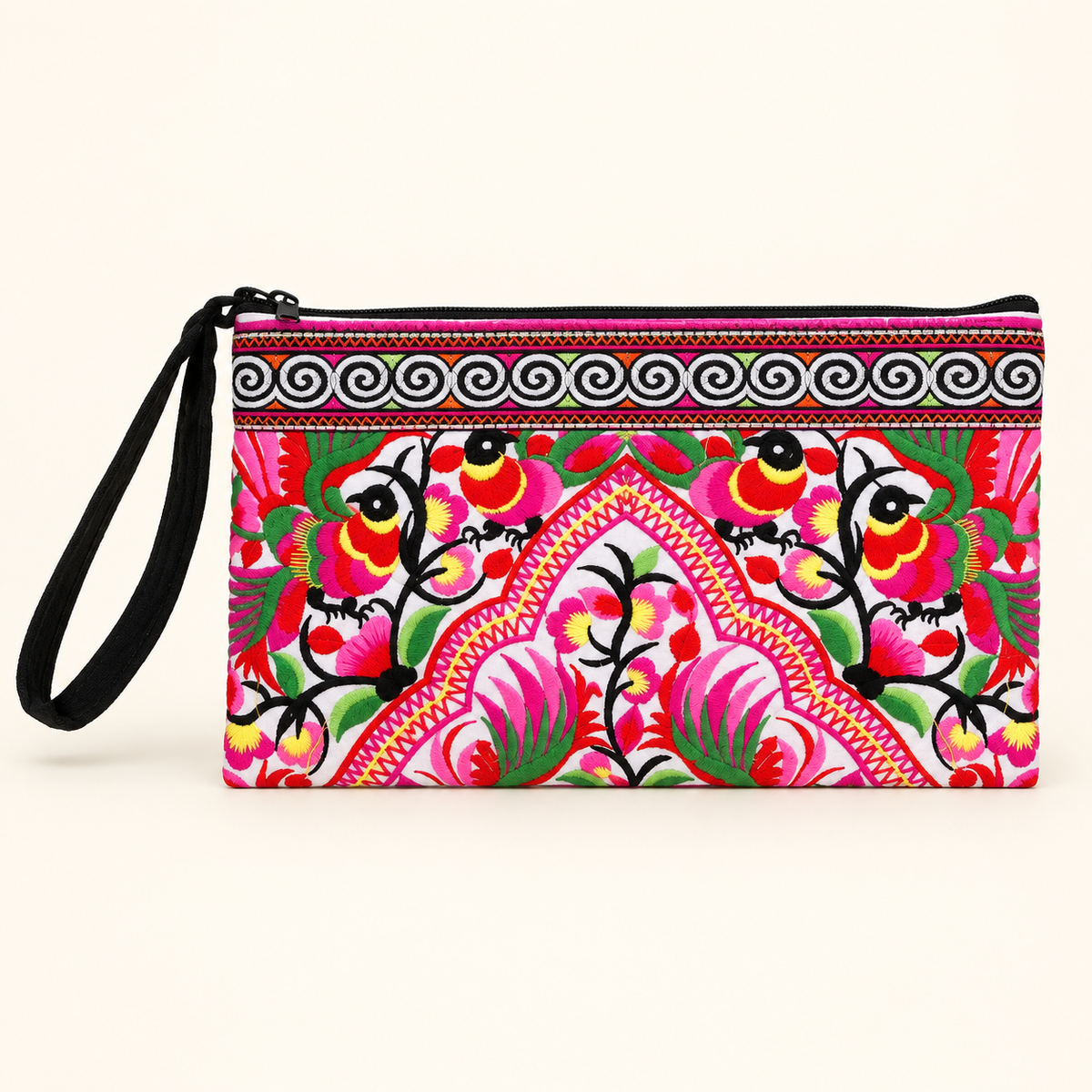 A rectangular wristlet clutch with a black wrist strap, featuring a vibrant, colorful folk-art style floral pattern on a cream background.