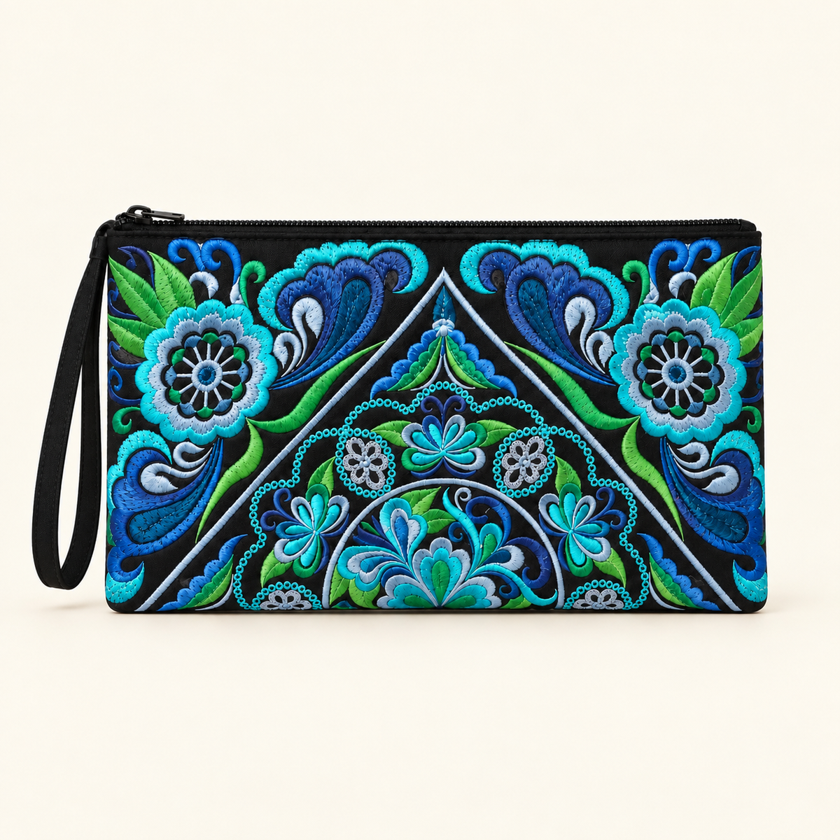 A black zipper pouch with a wrist strap, featuring a vibrant, symmetrical embroidered floral and geometric pattern in shades of blue, teal, and green on a cream background.