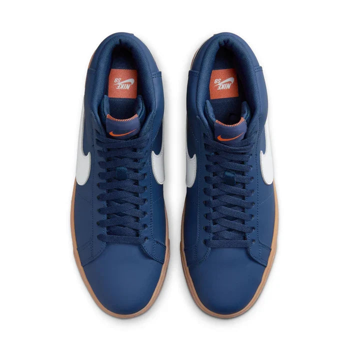 A pair of Nike high-top sneakers in navy blue suede with white Swoosh side logos, orange Nike Air text and swoosh details, and brown gum soles, shown from a top-down view on a white background.