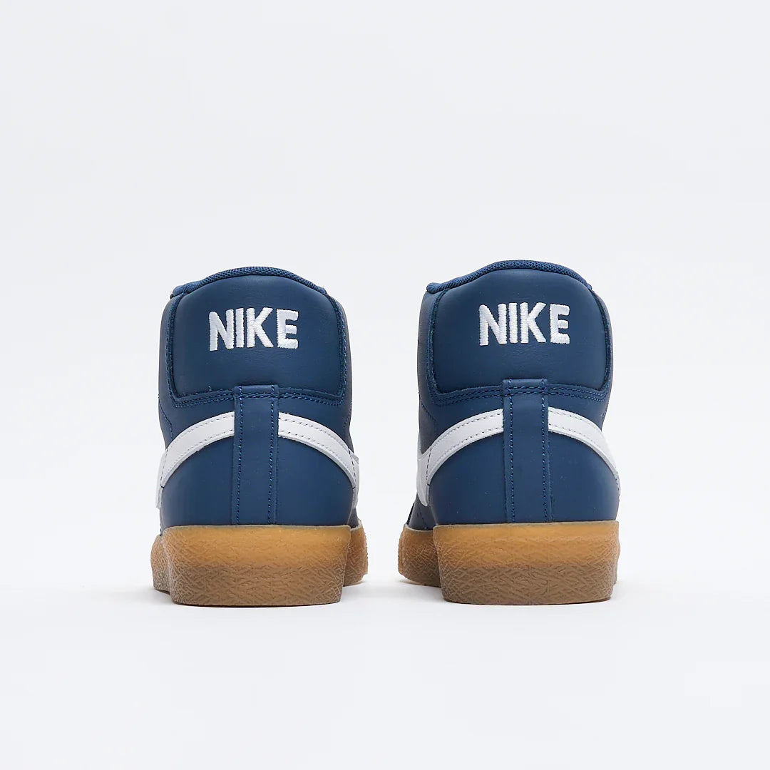 A pair of Nike high-top sneakers shown from the back, featuring a navy blue leather upper with a white Swoosh and white 'NIKE' branding on the heel tabs, finished with a brown gum sole.