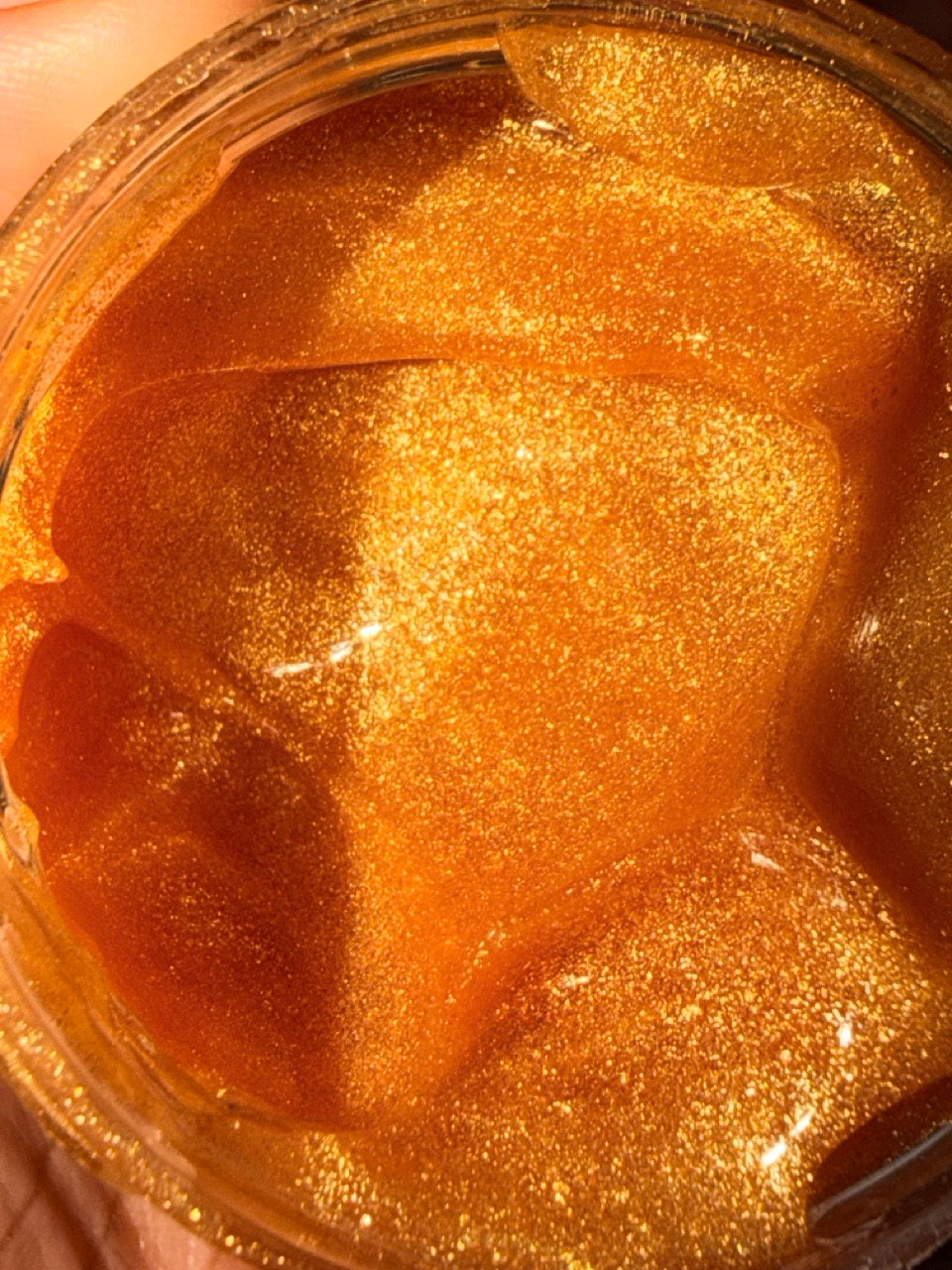 24K Gold Jelly Face Mask close-up with shimmering gold gel texture in a reusable jar, vegan skincare made with natural ingredients, clean beauty, cruelty free, paraben free, gluten free, recyclable packaging, female owned brand, hydrating facial mask for radiant glowing skin.