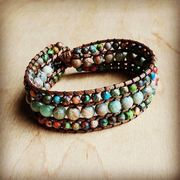 Impression Jasper Woven Bracelet Multi Color Weave some natural magic into your accessory collection with this stunning Impression Jasper bracelet. Three genuine stone strands intertwine to create a one-of-a-kind woven pattern that plays beautifully with multiple color tones. At 1" wide and 9" long, it's the ideal size for stacking or wearing solo. Whether you're dressing up or keeping it casual, this versatile piece adds just the right touch of earthy charm to any outfit.