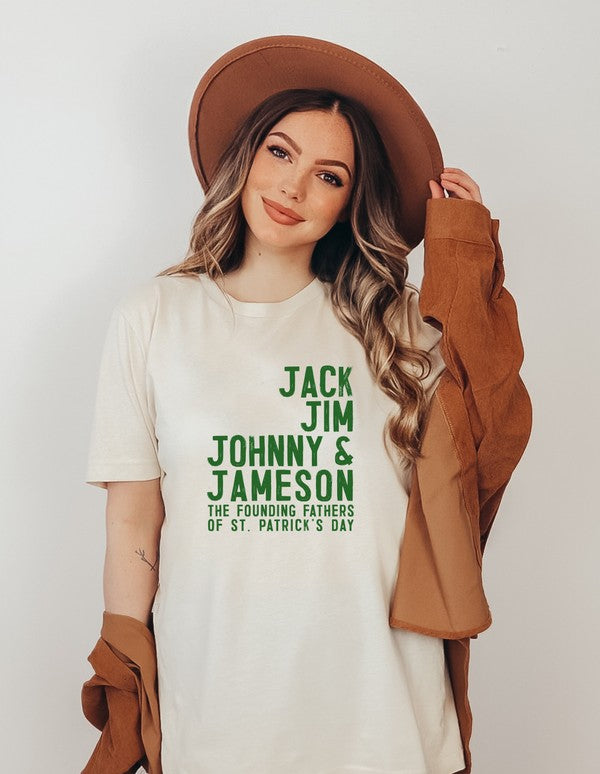 Woman modeling a white St. Patrick's Day graphic T-shirt featuring green "Jack Jim Johnny & Jameson – The Founding Fathers of St. Patrick's Day" text, paired with jeans and a brown hat.