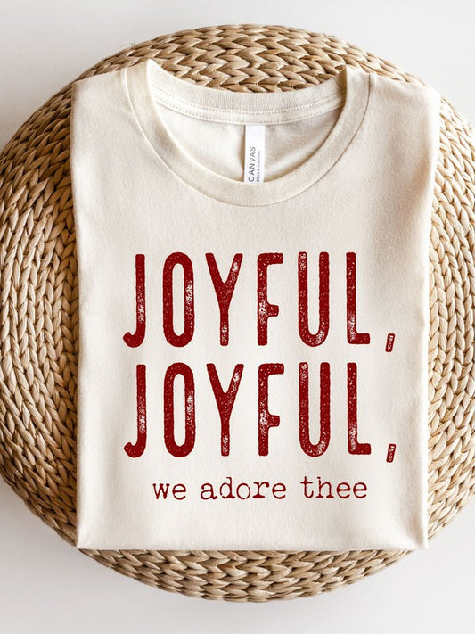 Cream and red t-shirt with red text 'JOYFUL, JOYFUL, we adore thee' on a woven surface.