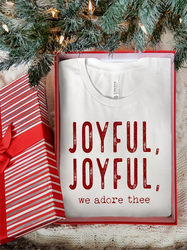 Cream and red t-shirt with red text 'JOYFUL, JOYFUL, we adore thee' on a woven surface.
