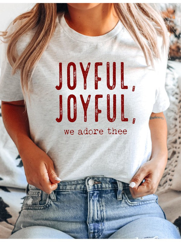 Cream and red t-shirt with red text 'JOYFUL, JOYFUL, we adore thee' on a woven surface.