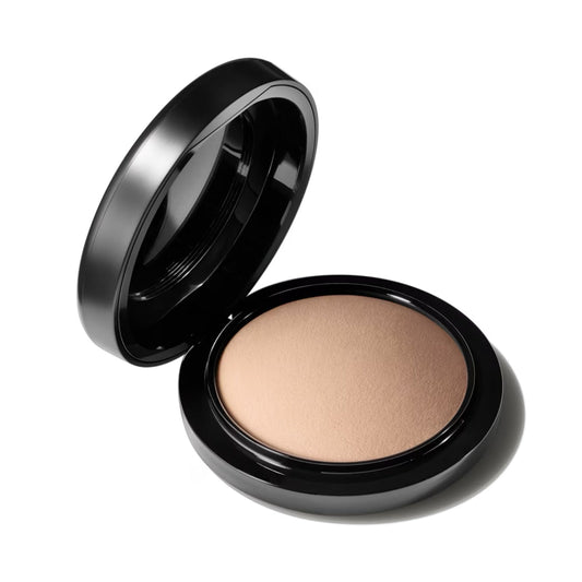 Compact powder in a black case on a white background