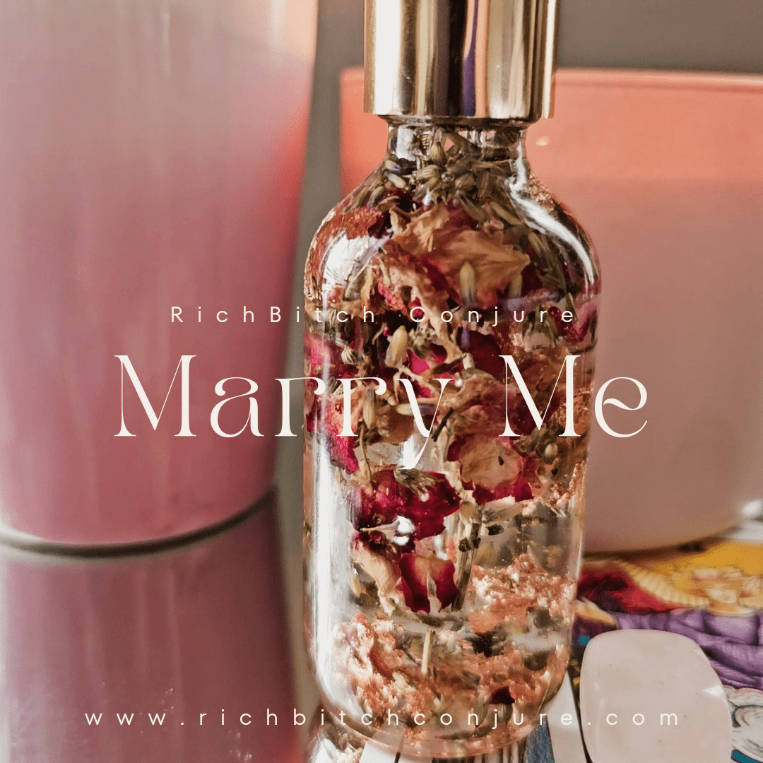 Perfume bottle with dried flowers labeled 'Marry Me' by Rich Bitch Conjure. Marry Me Hoodoo Conjure Oil | Commitment Oil | Love and Marriage Ritual Oil | Relationship Rootwork Oil | Spiritual Supply