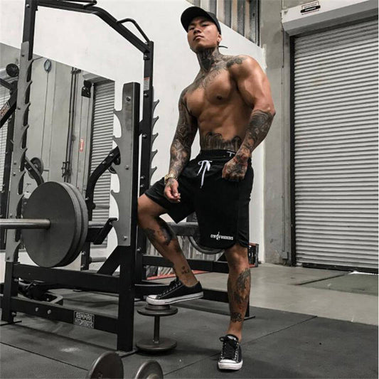 Men's Drawstring Mesh Quick Dry Fitness Shorts Black Gym Shorts
 Muscular man with tattoos in a gym setting