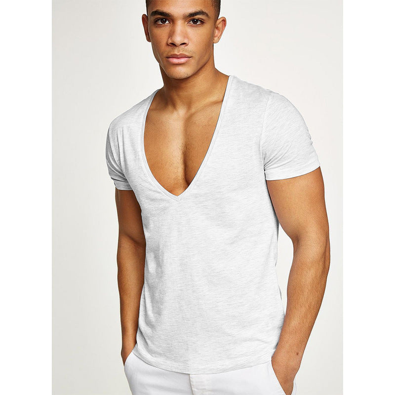Man wearing a white V-neck t-shirt against a plain background