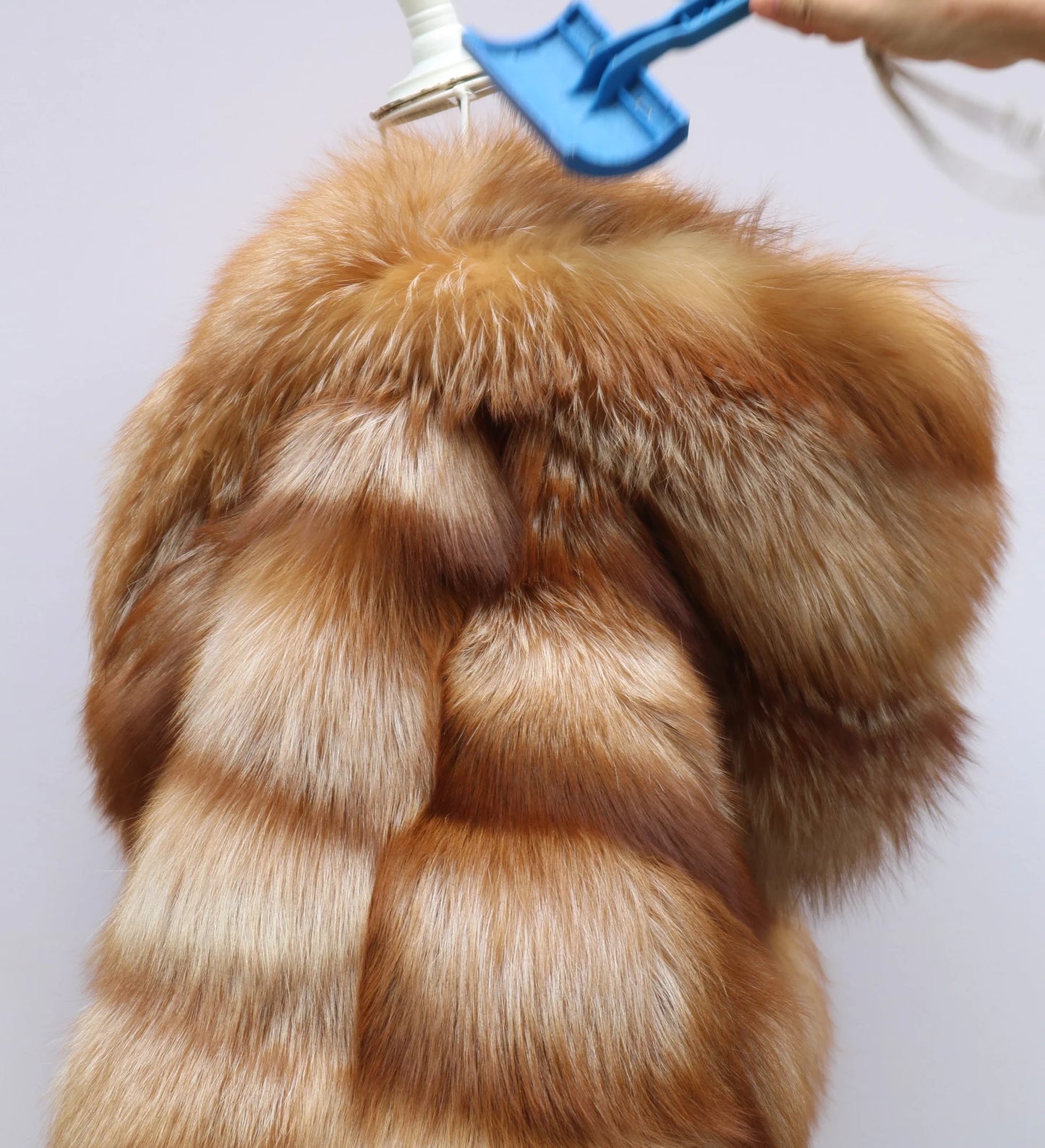 Brown fur coat on a hanger against a white background. Natural Golden Fox Fur Coat with Batwing Sleeve & Double-Sided