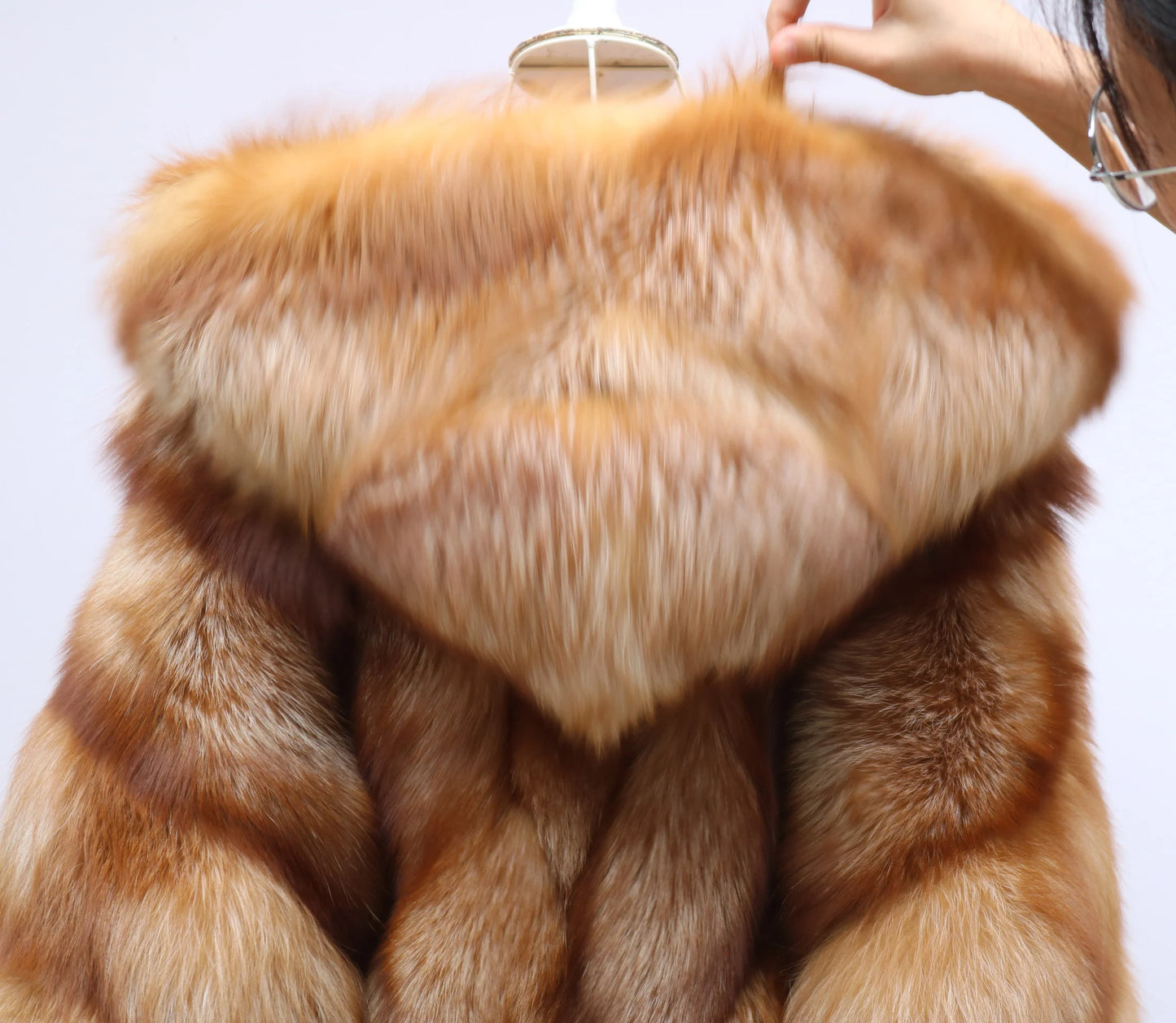 Close-up of a brown fur coat with a white background. Natural Golden Fox Fur Coat with Batwing Sleeve & Double-Sided