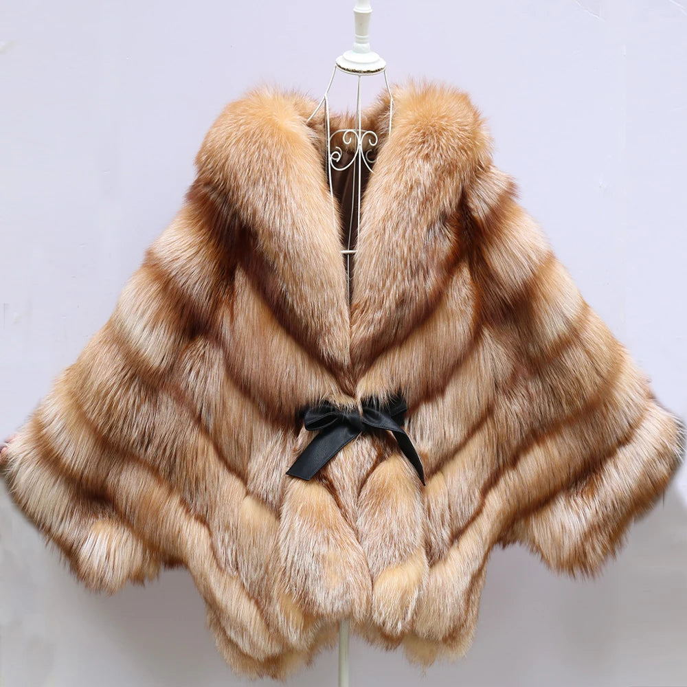 Fur poncho with a black bow on a mannequin against a light background. Natural Golden Fox Fur Coat with Batwing Sleeve & Double-Sided