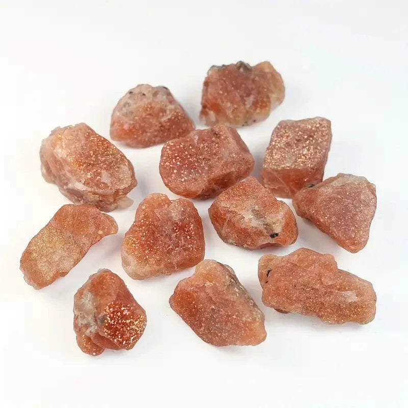 Collection of rough orange stones Natural Rough Sunstone Crystal Stones – 5pcs / 10pcs High Quality Raw Crystals for Tumbling, Cabbing, Polishing, Wire Wrapping, Wicca &amp; Reiki

Bring the warmth of the sun into your space with these shimmering natural rough Sunstone crystals. Each raw piece glows with golden, peach and coppery flashes, making it perfect for spiritual work, crystal crafting, or simply adding a radiant touch to your altar or home décor.