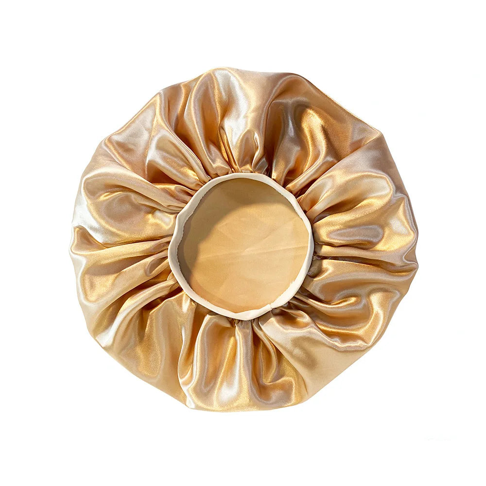 Gold satin hair scrunchie on a white background
