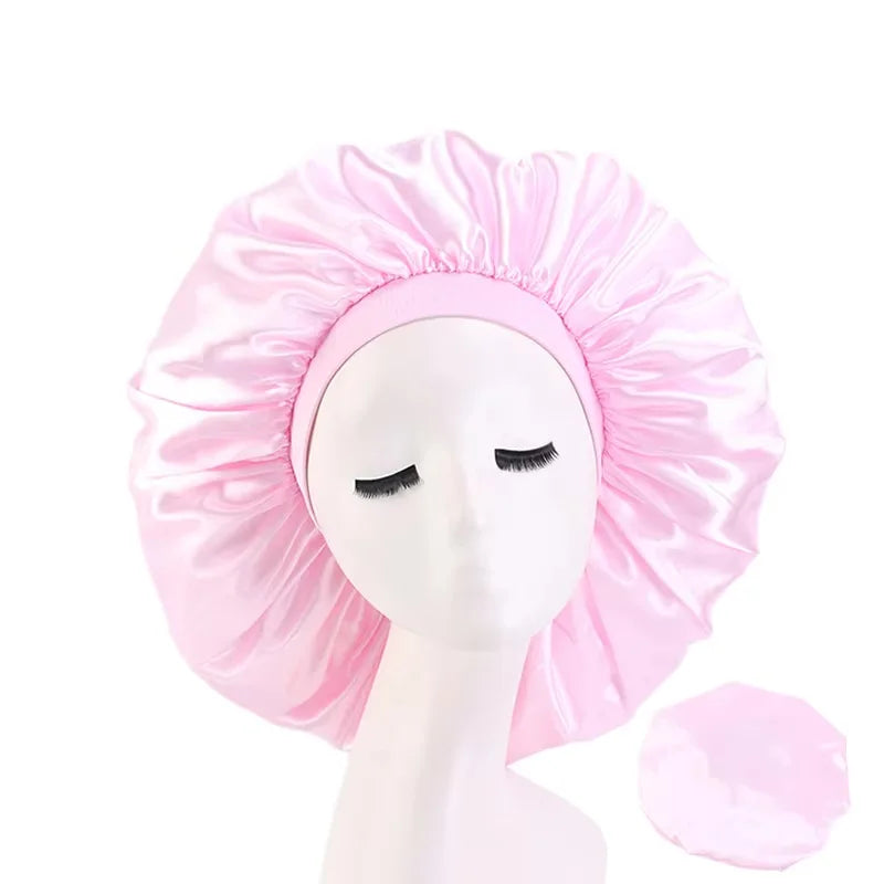Pink satin bonnet on a mannequin head with a white background